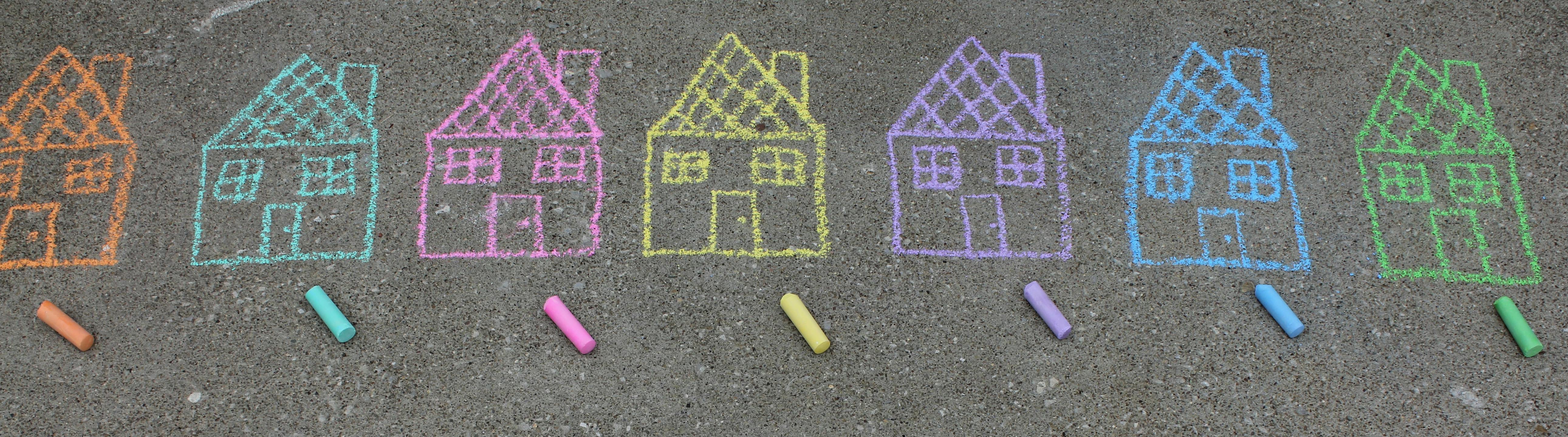 Children's chalk drawing of colourful houses