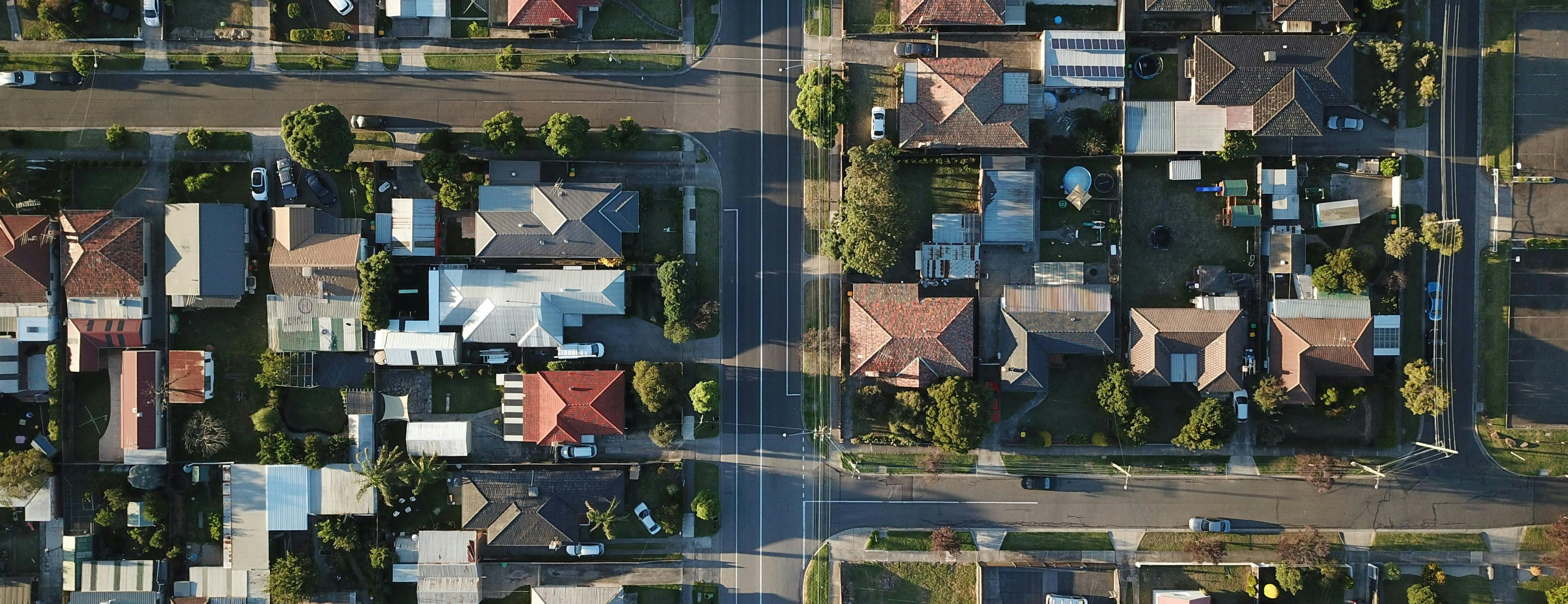 Birds-eye view looking down onto a neighbourhood with lots of houses and streets