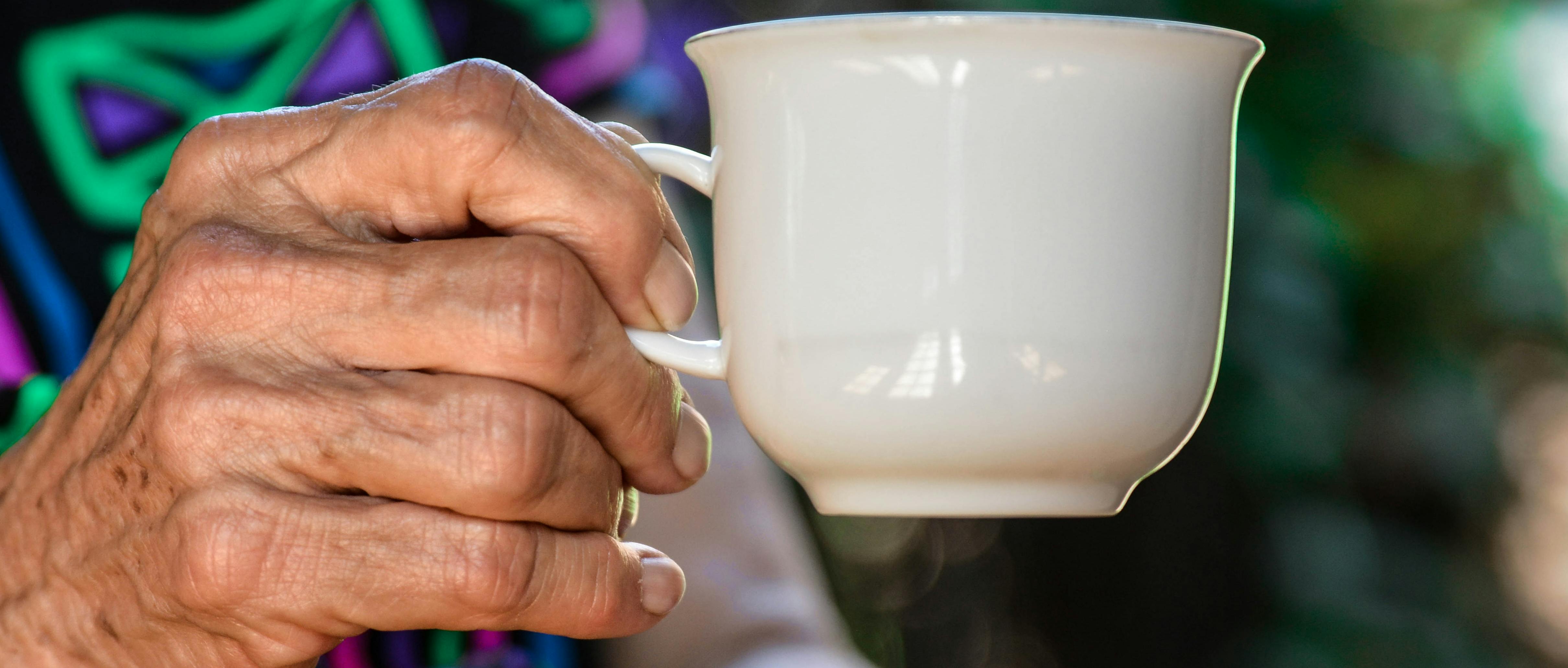 Older person holding a cup of tea