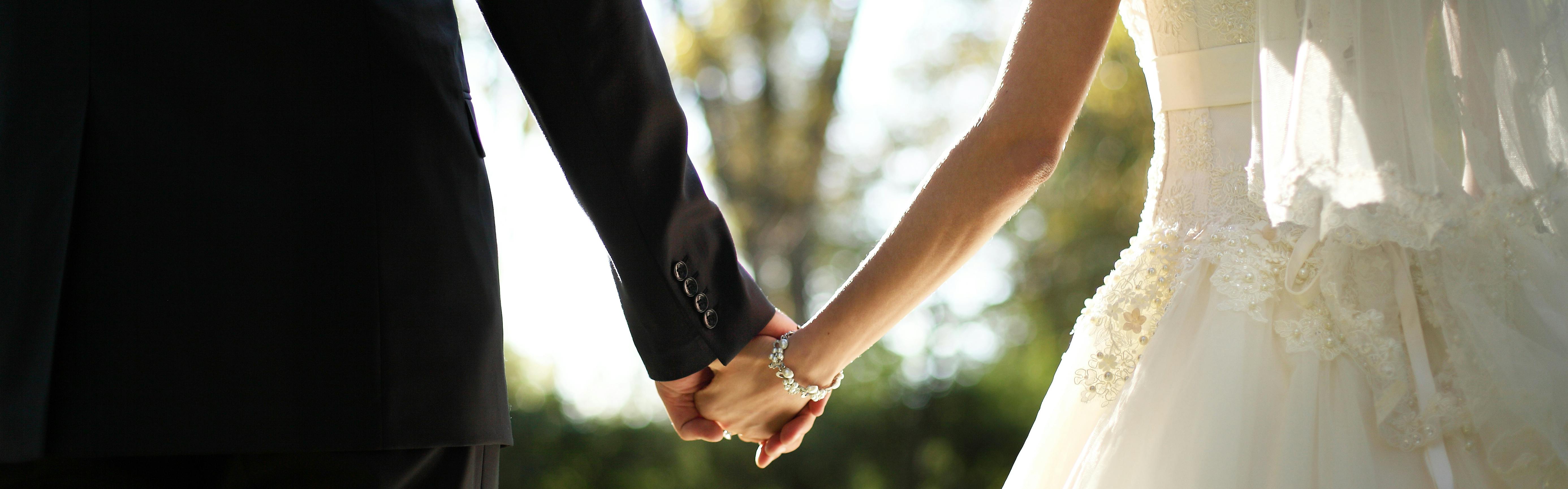 Wedding bride and groom holding hands