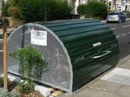 These are photos of a closed and open bike hangar