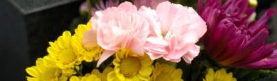 Image of flowers beside a grave (stock photo)