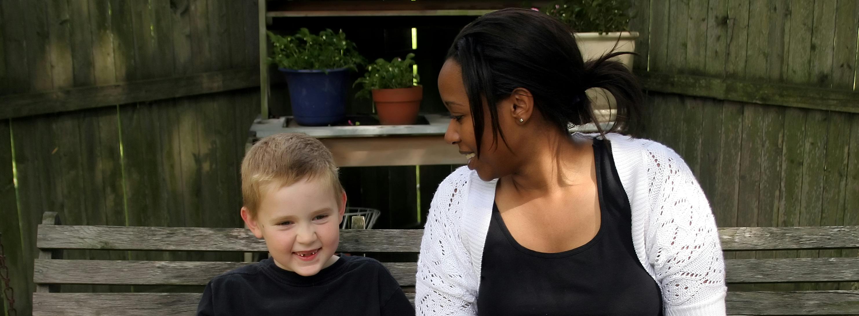 Adult and child sat on a bench