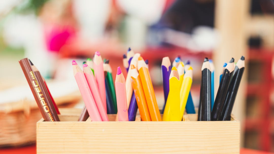 Wooden box containing colouring pencils