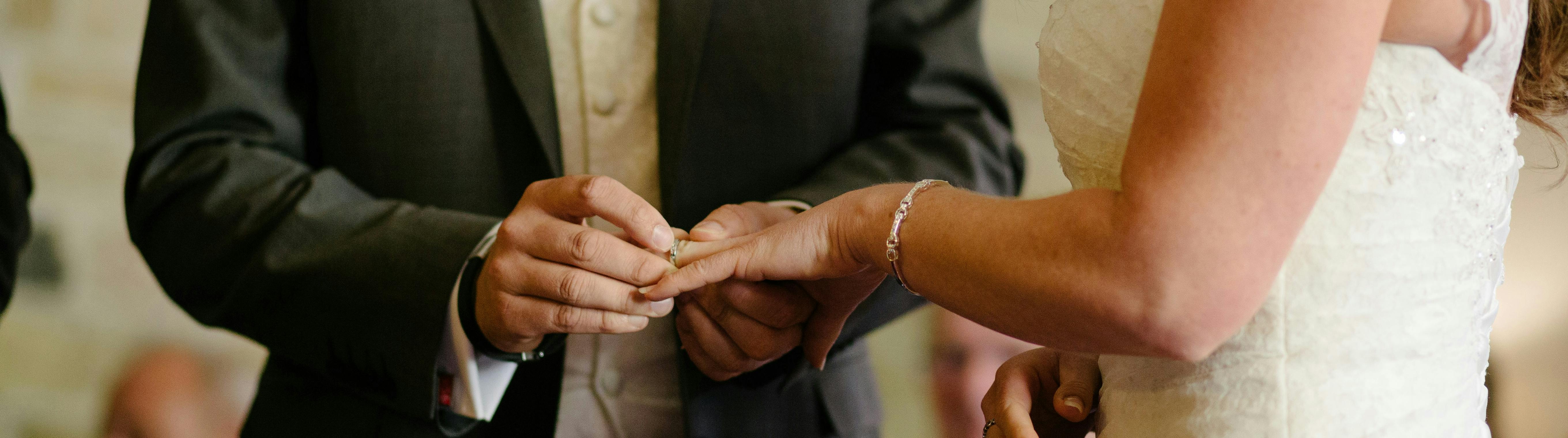 Bride and groom exchanging rings