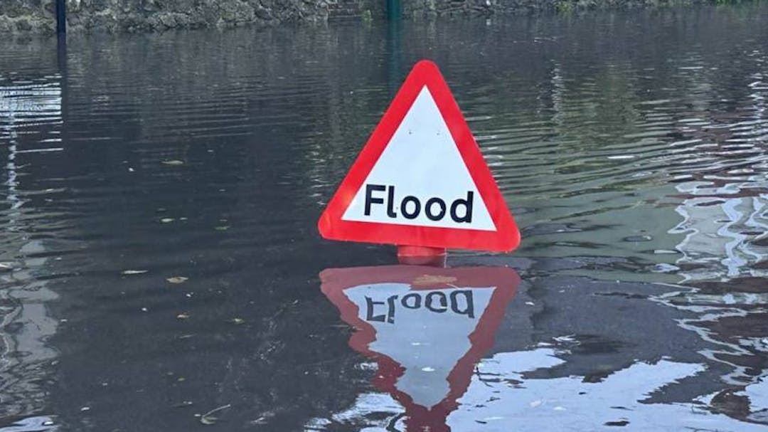 Flood sign in a flooded road