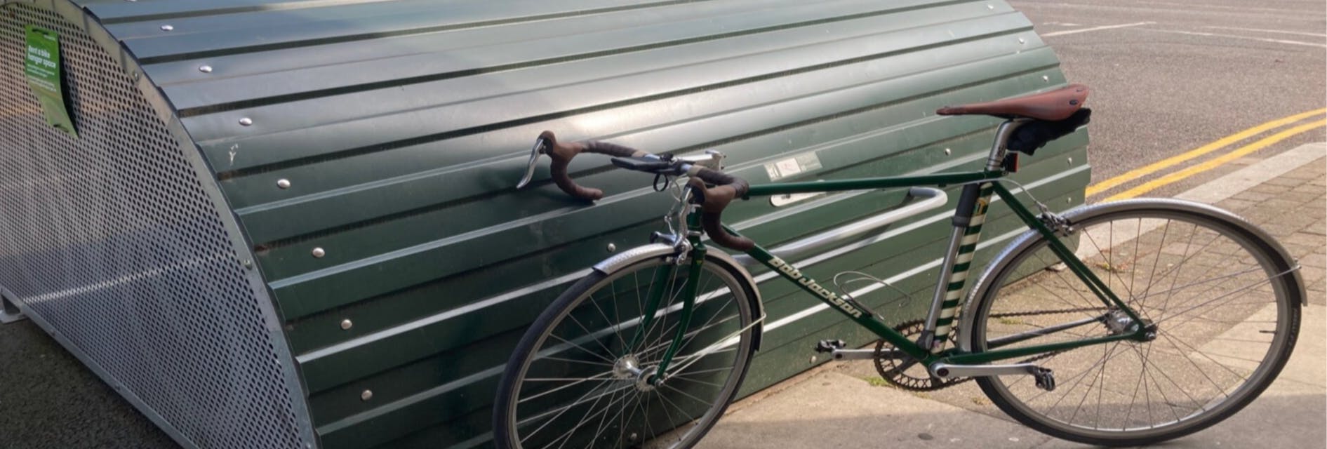 A bike hangar with a bicycle leaning on it 