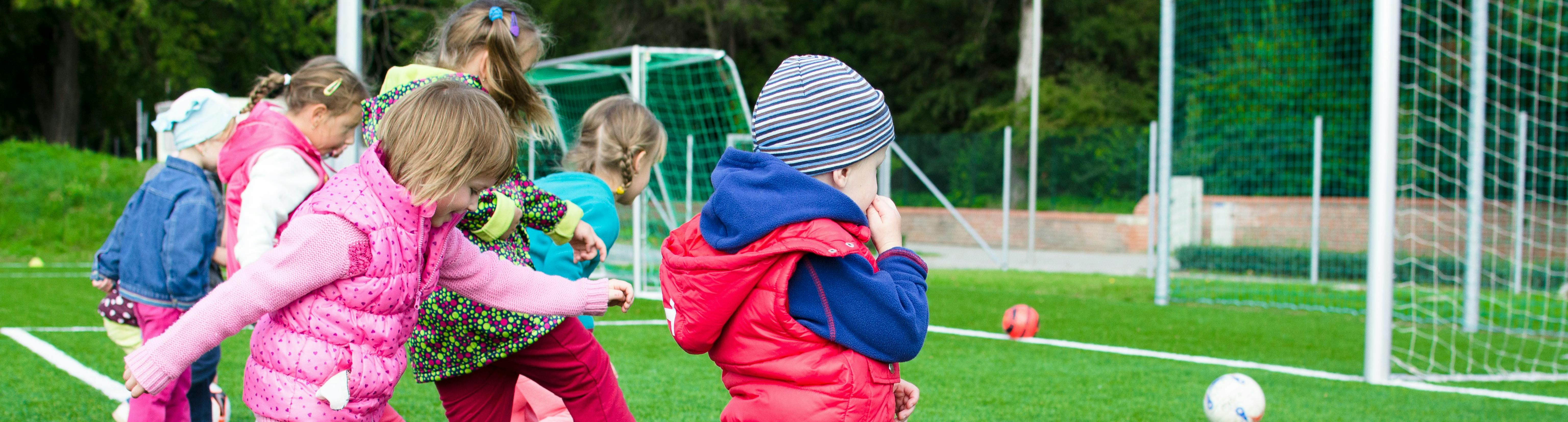 Young children playing football