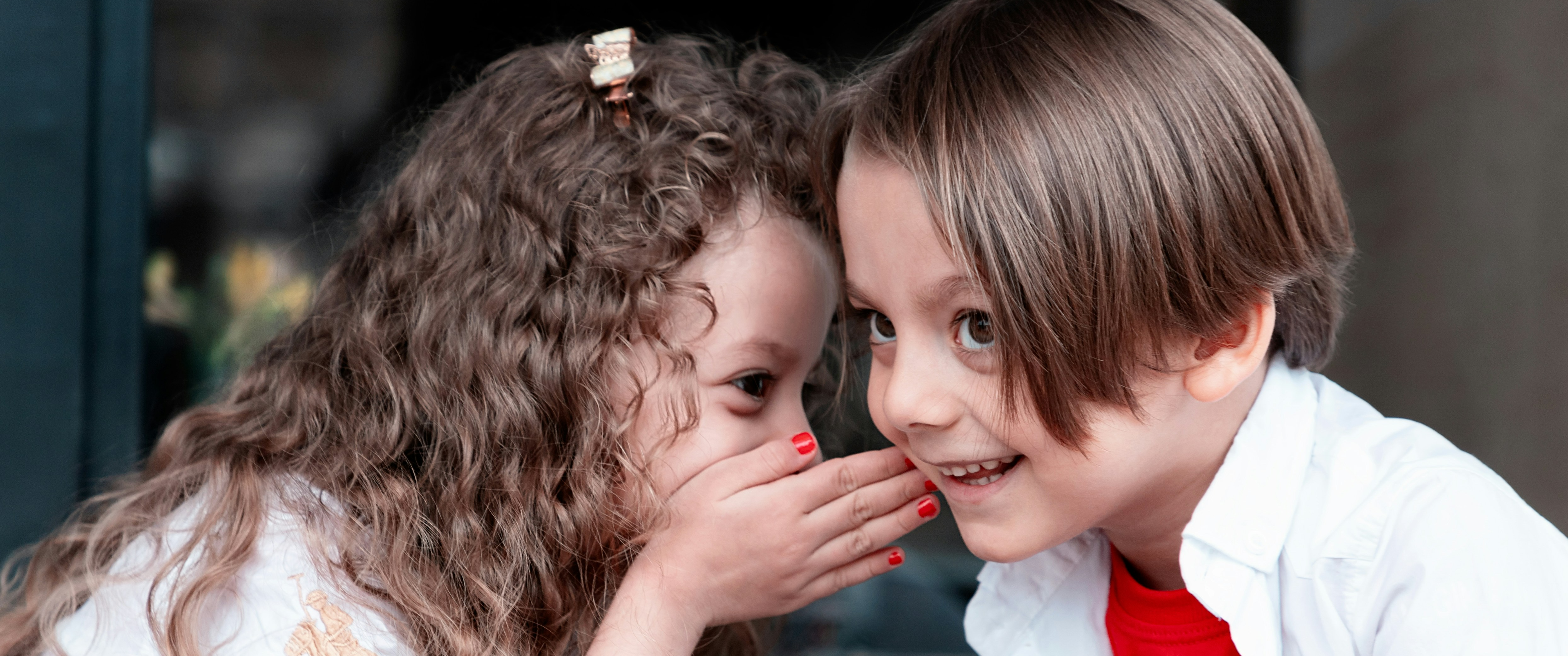 Children telling each other a secret