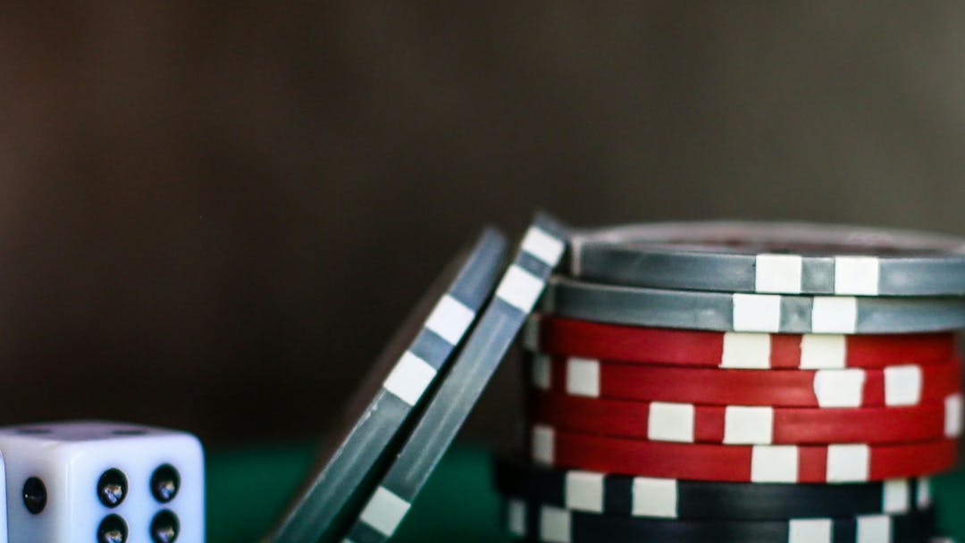 two dice and a stack of poker chips