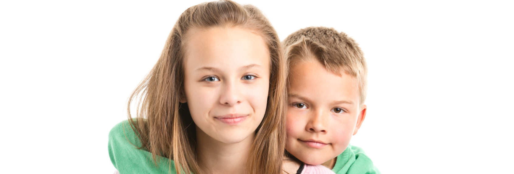 Young boy with arms round young girl