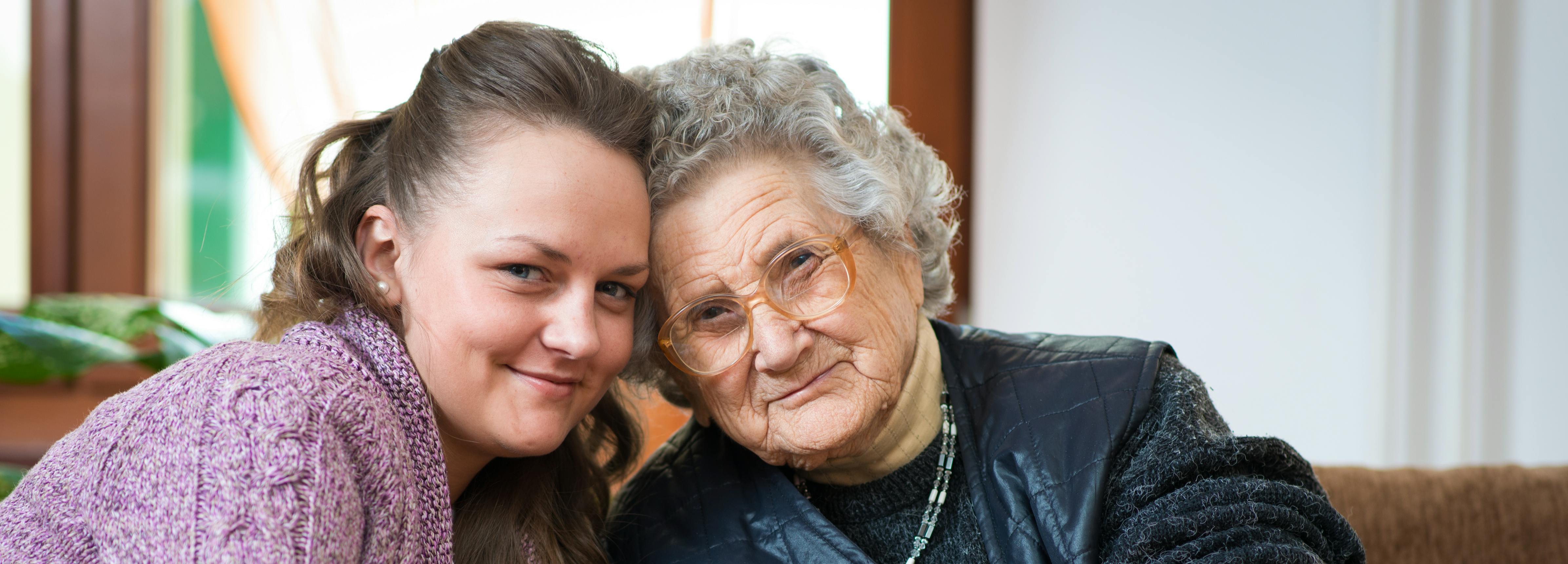 Younger woman hugging an older women