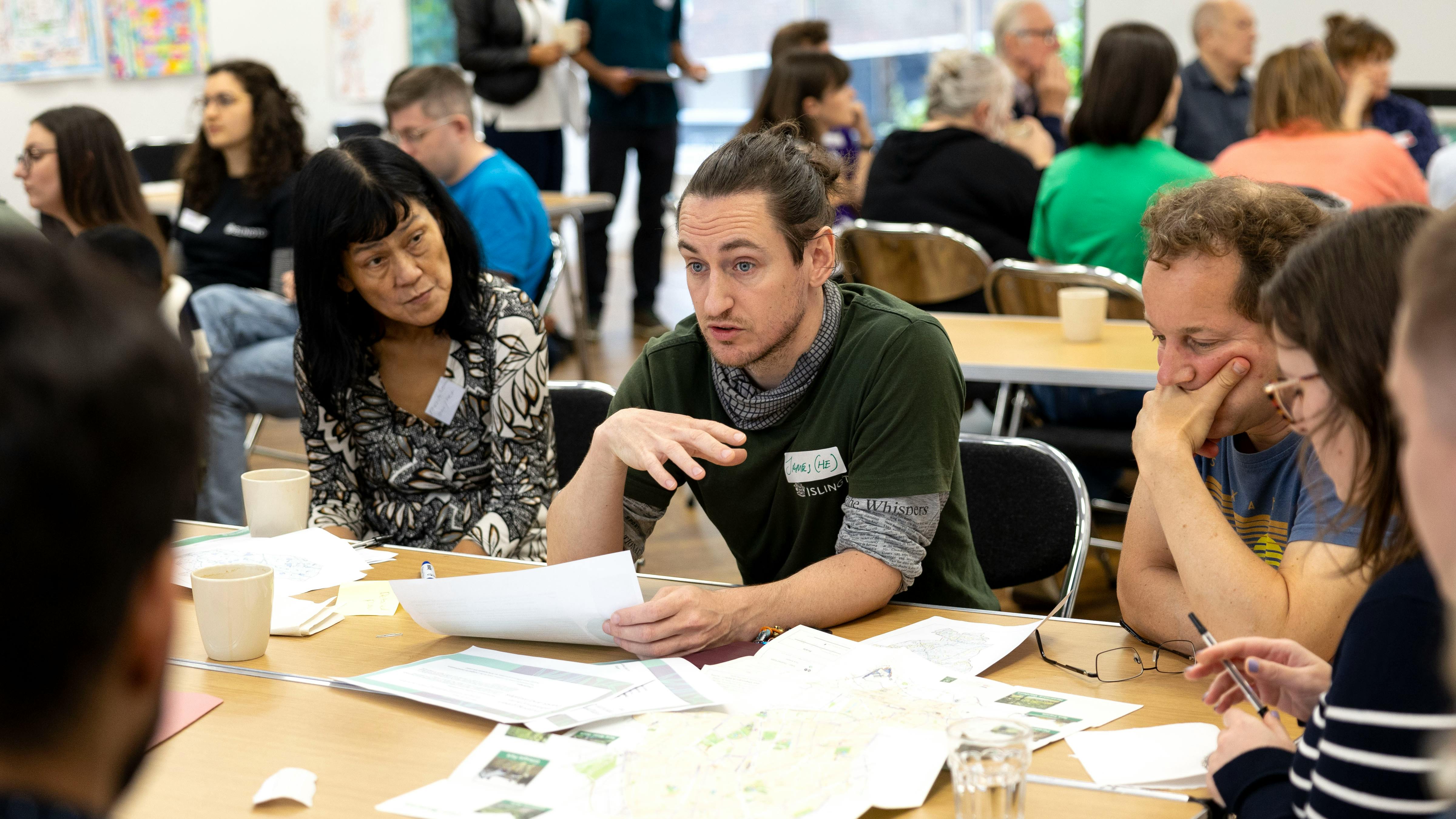 A man and woman having a conversation at the Islington Climate Panel workshop 