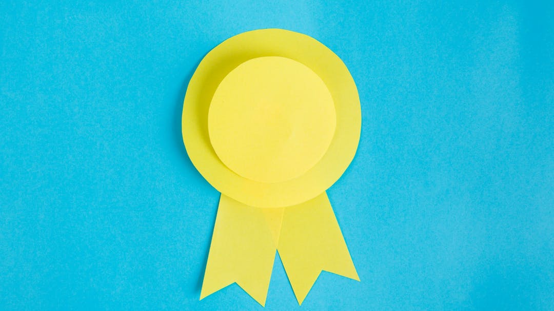 Image of a yellow rosette on a blue background