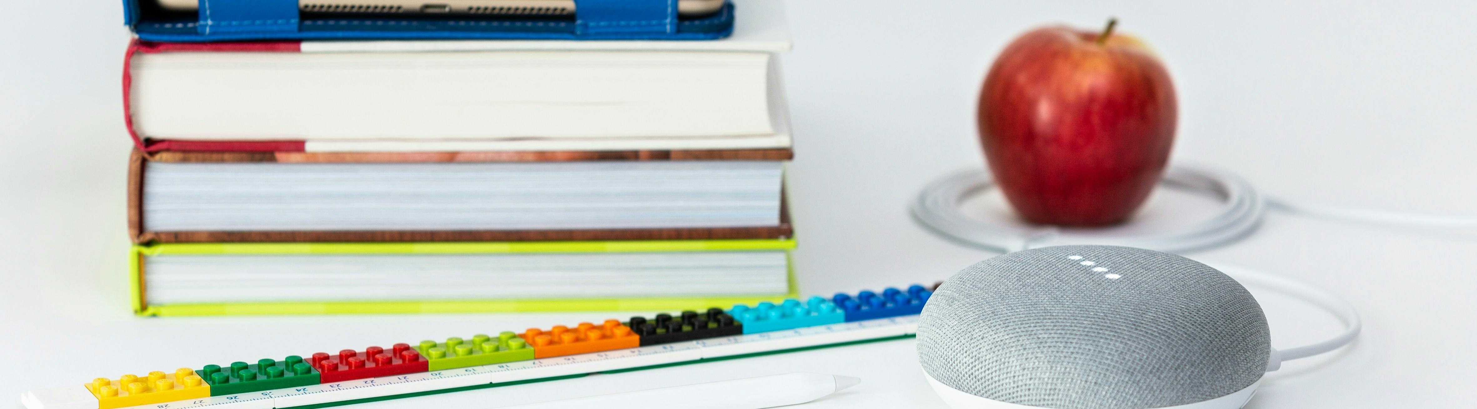 Pile of book and an apple