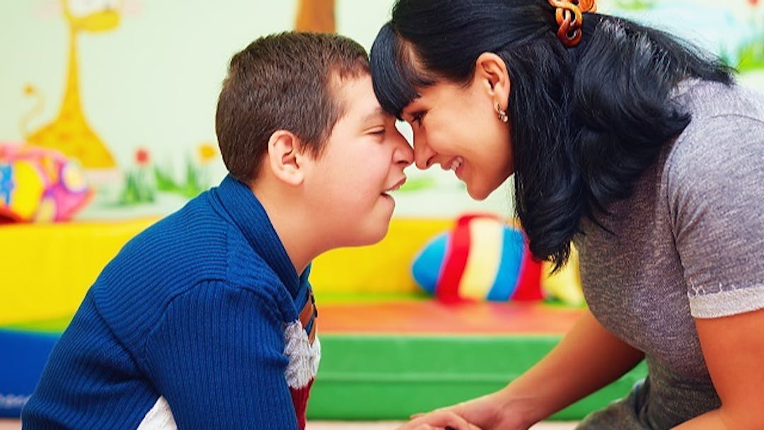 woman and boy smiling and touching foreheads