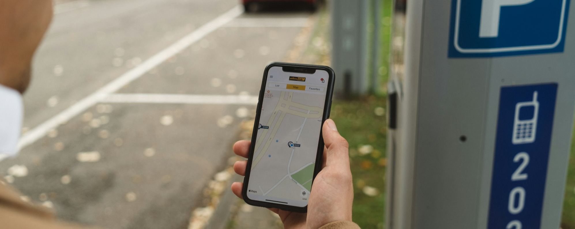 A person paying for parking on a mobile phone
