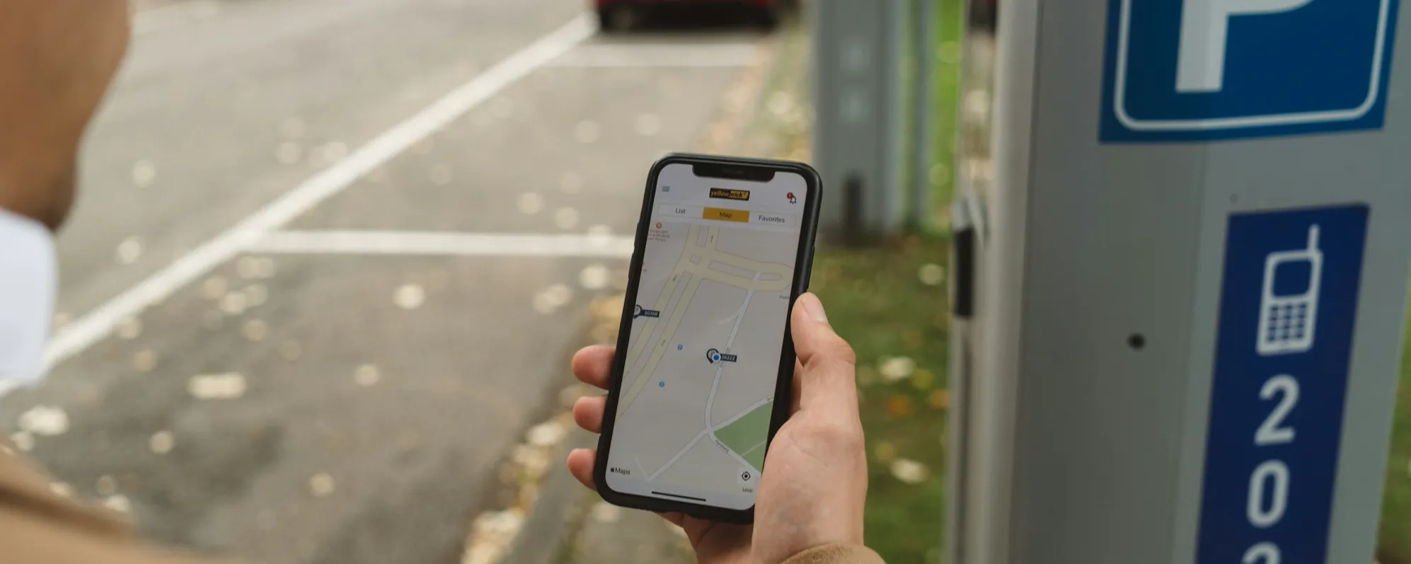 A person paying for parking on a mobile phone