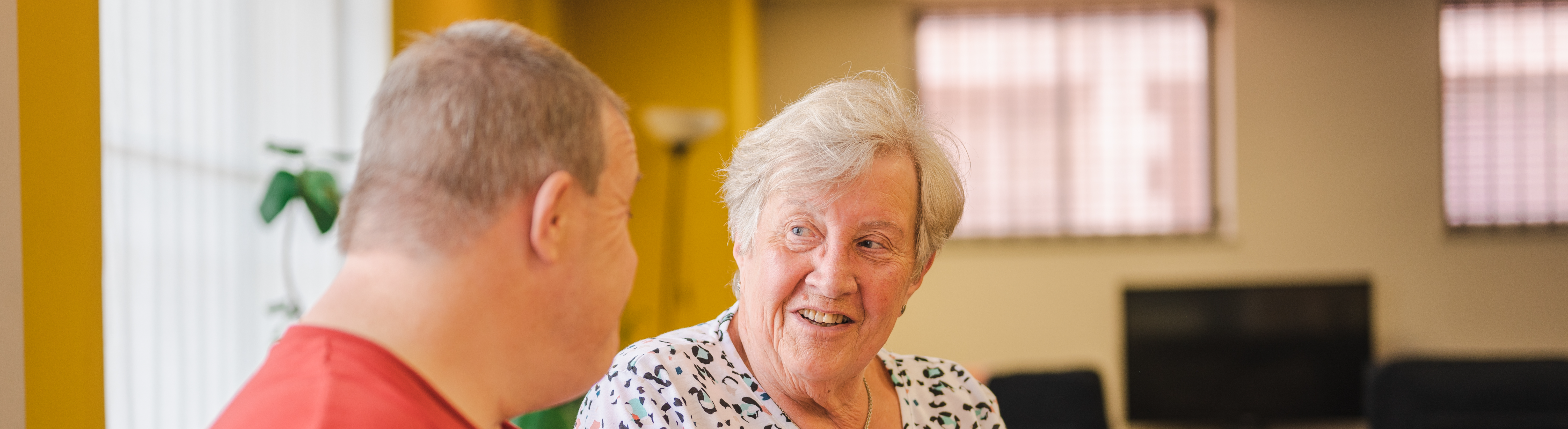 Two people chatting sitting at a table
