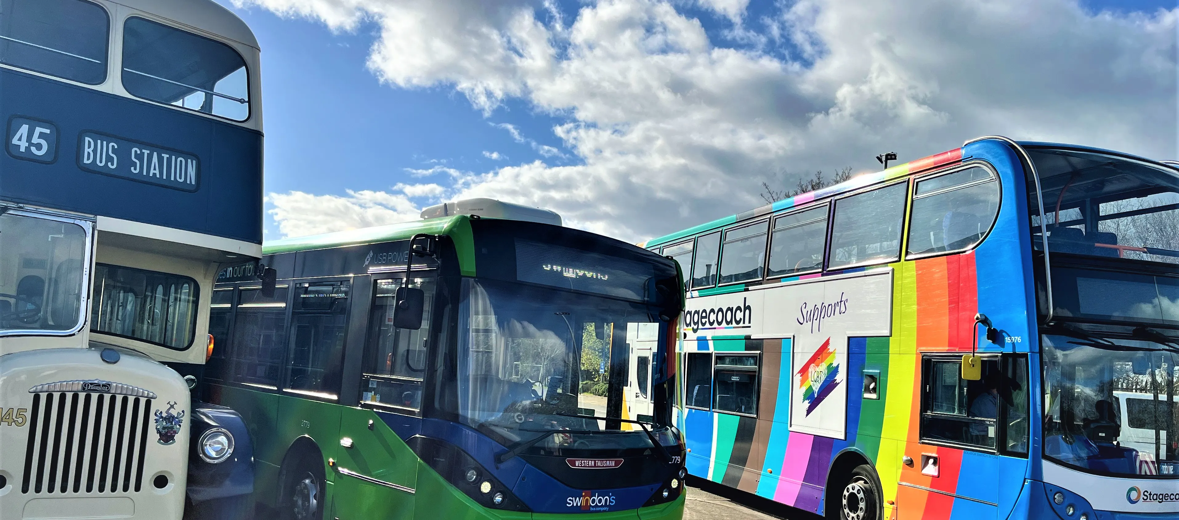 3 parked buses with a blue sky background