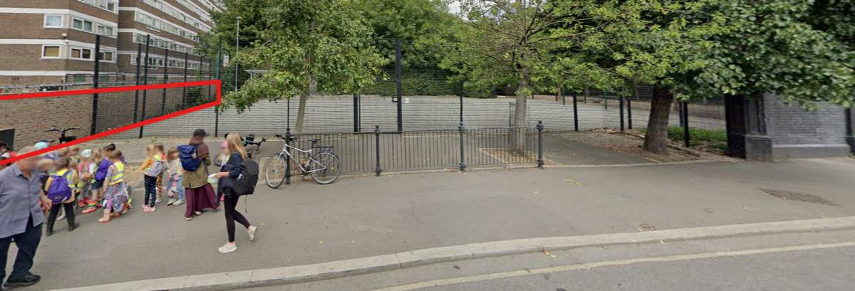 A group of adults and children standing near the play zone (highlighted by a red outline) in Caledonian Park