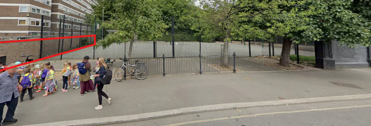 A group of adults and children standing near the play zone (highlighted by a red outline) in Caledonian Park