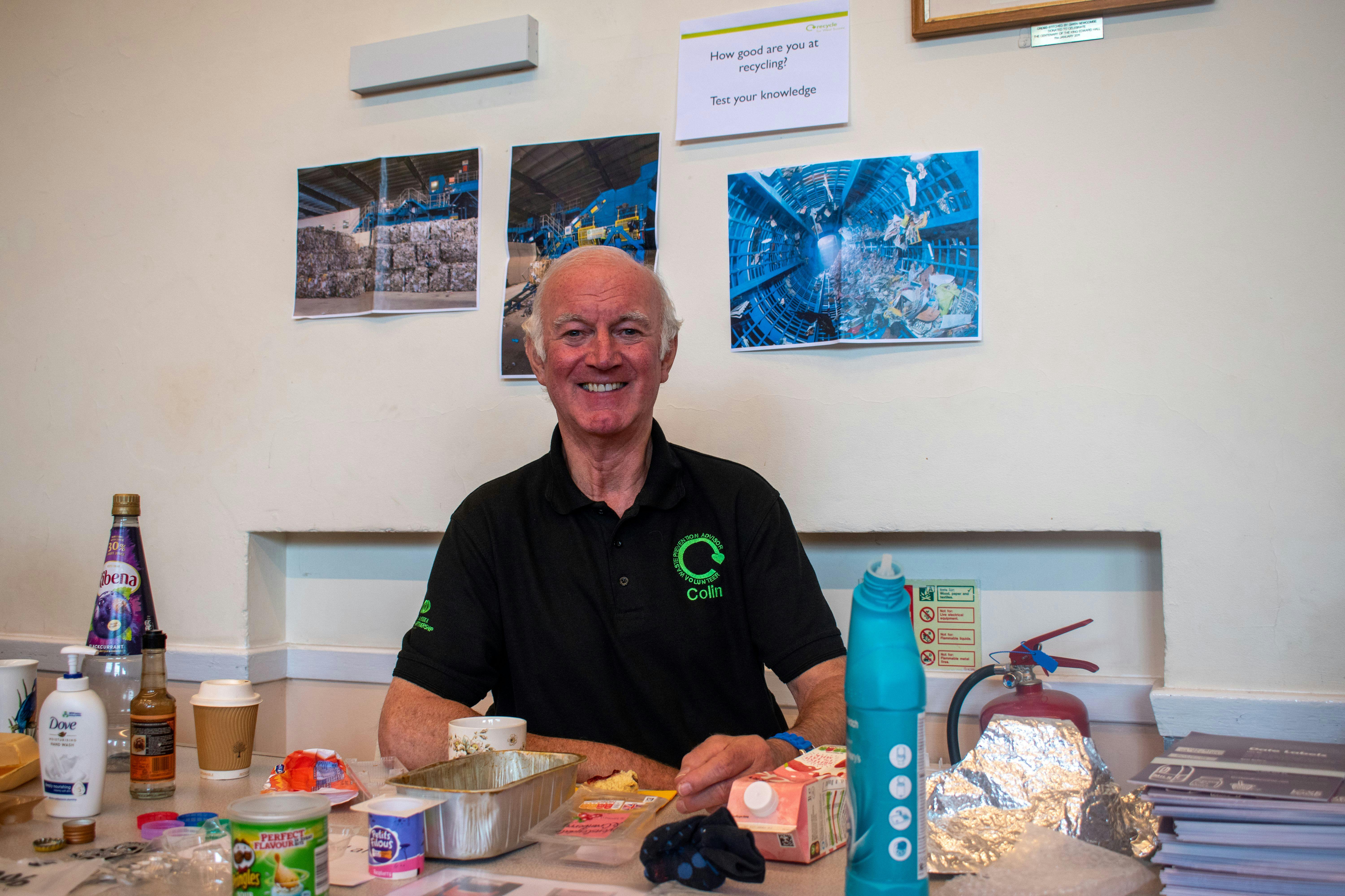 Waste Prevention Volunteer surrounded by recycling 