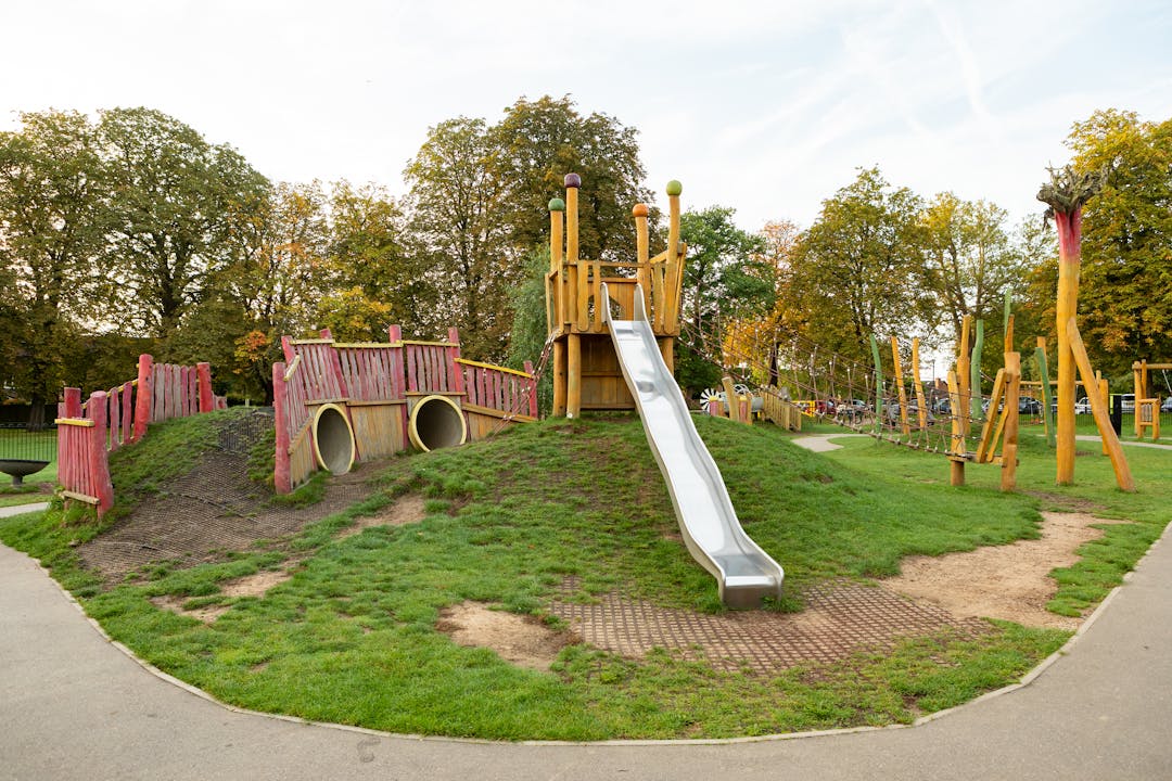 outdoor park with a climbing frame and a slide