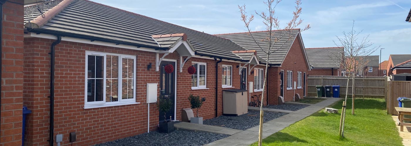 A row of bungalows with trees in front