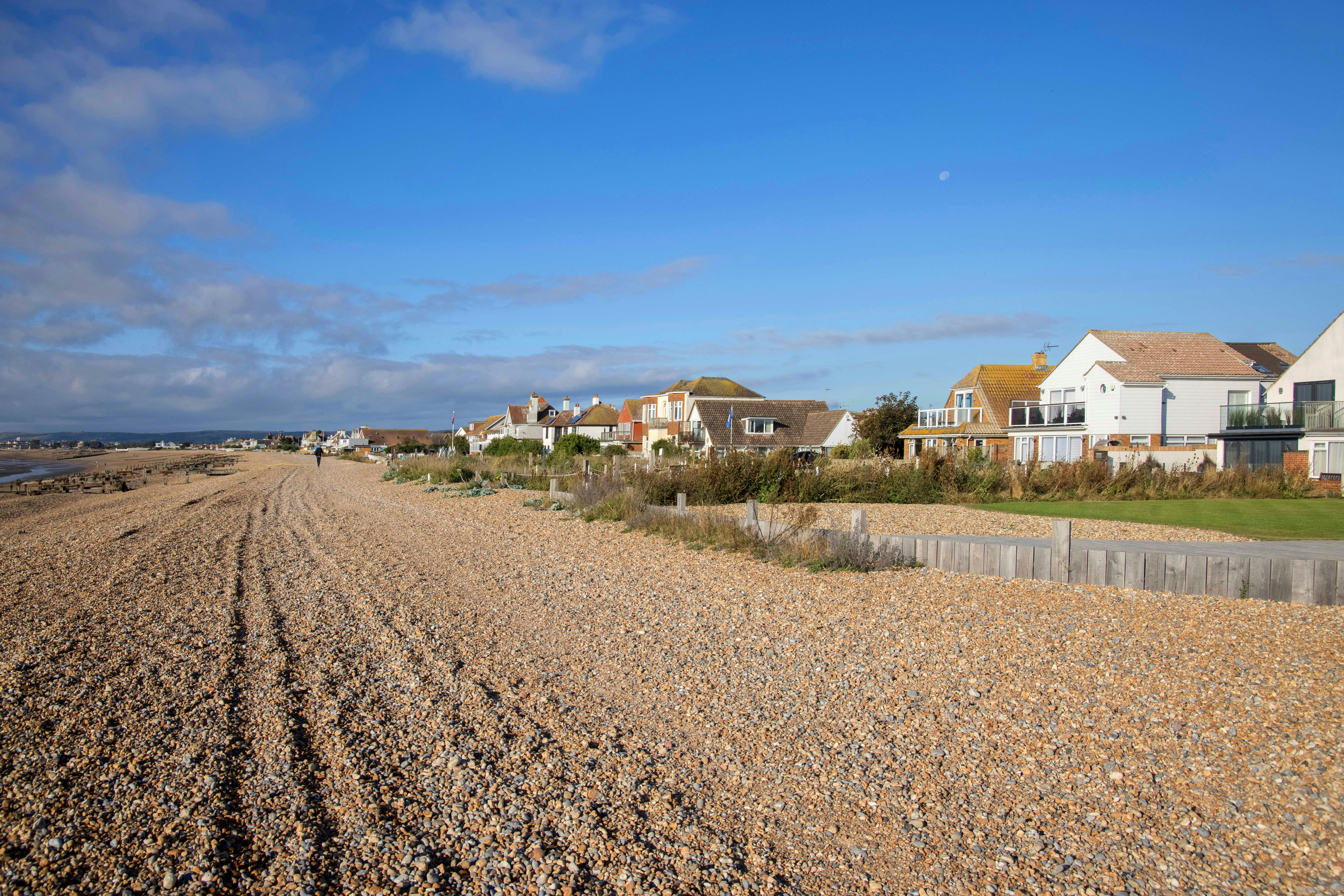 The beach at Pevensey Bay and houses on the beach crest