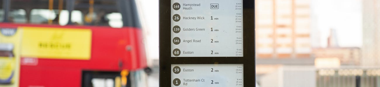 Bus timetable showing routes 1, 168 and 188 with a bus in the background