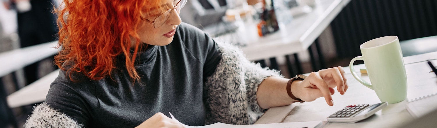 An image of a woman using a using maths skills at work.
