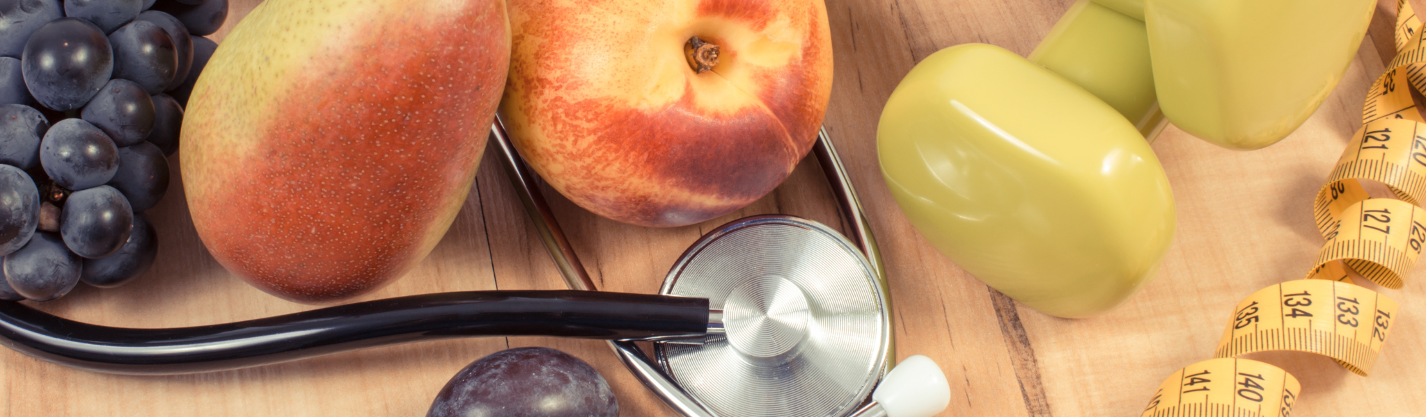 An image of fruit along with a stethoscope and measuring tape.