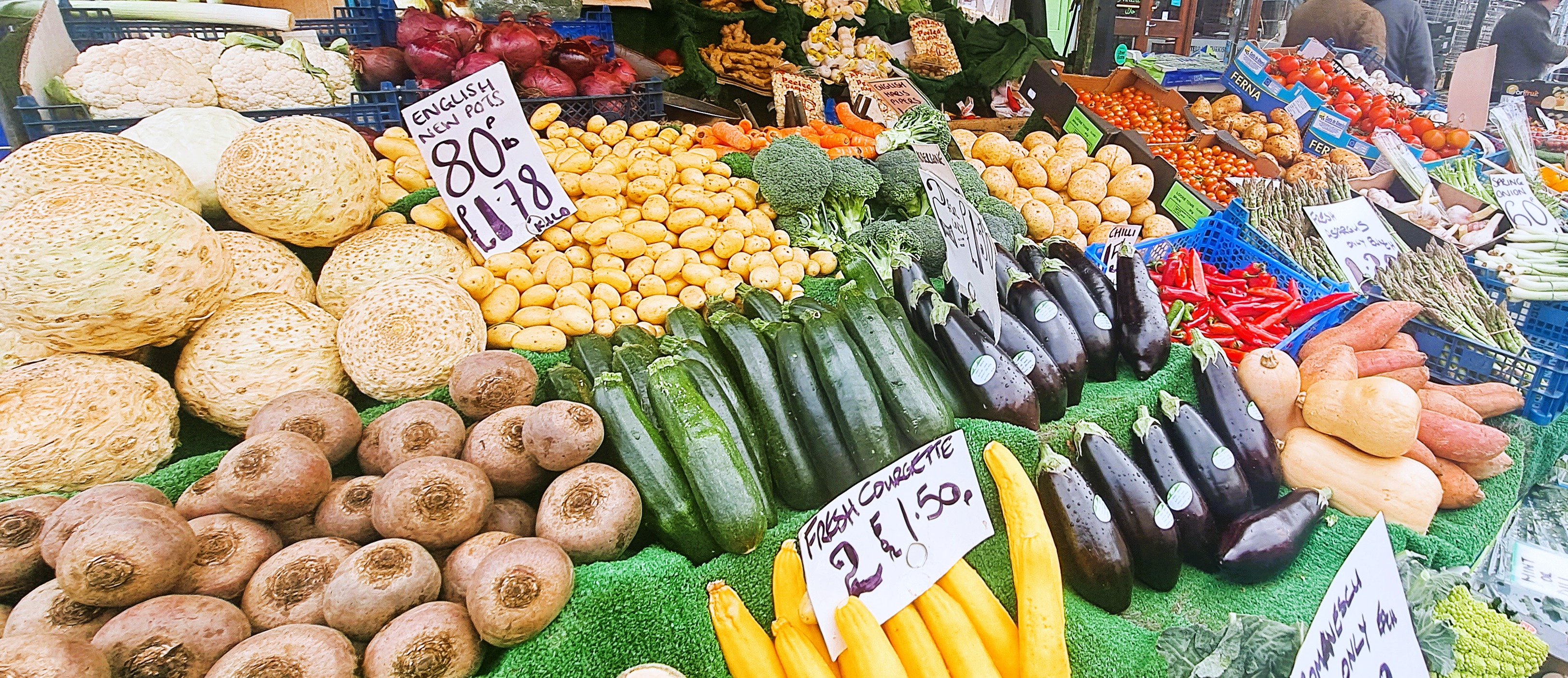 An open market stand displaying a variety of vegetables