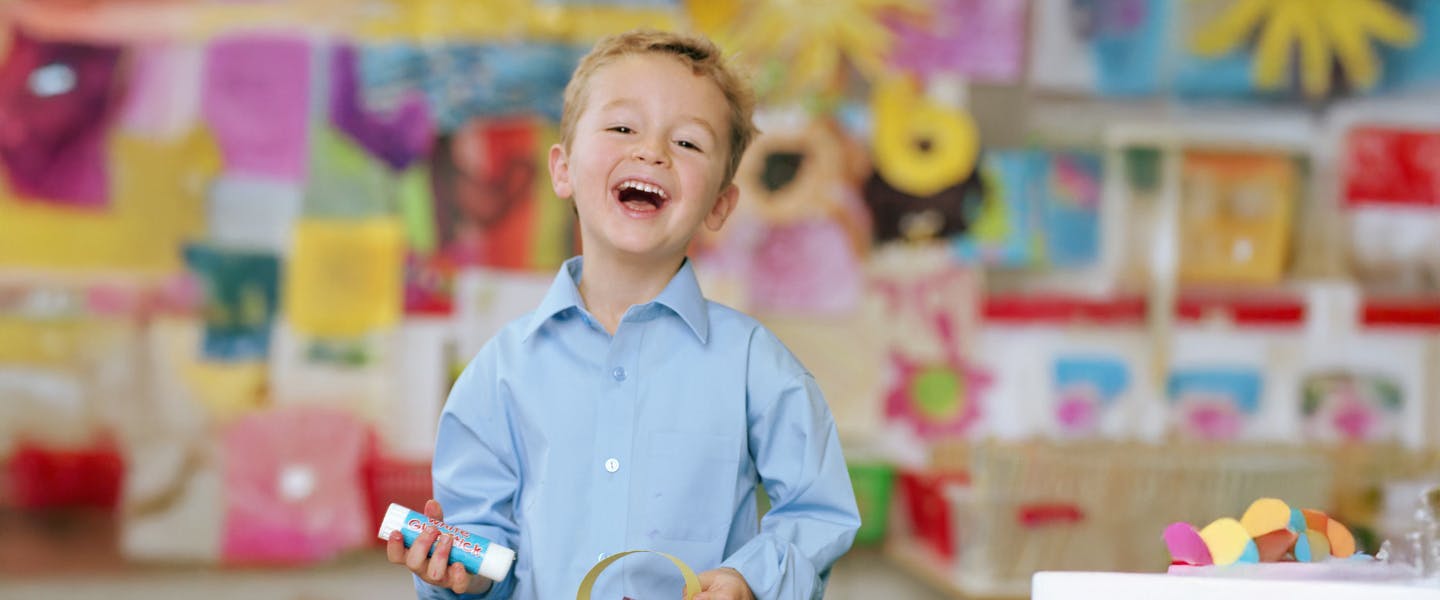 Primary school aged child laughing in a classroom setting