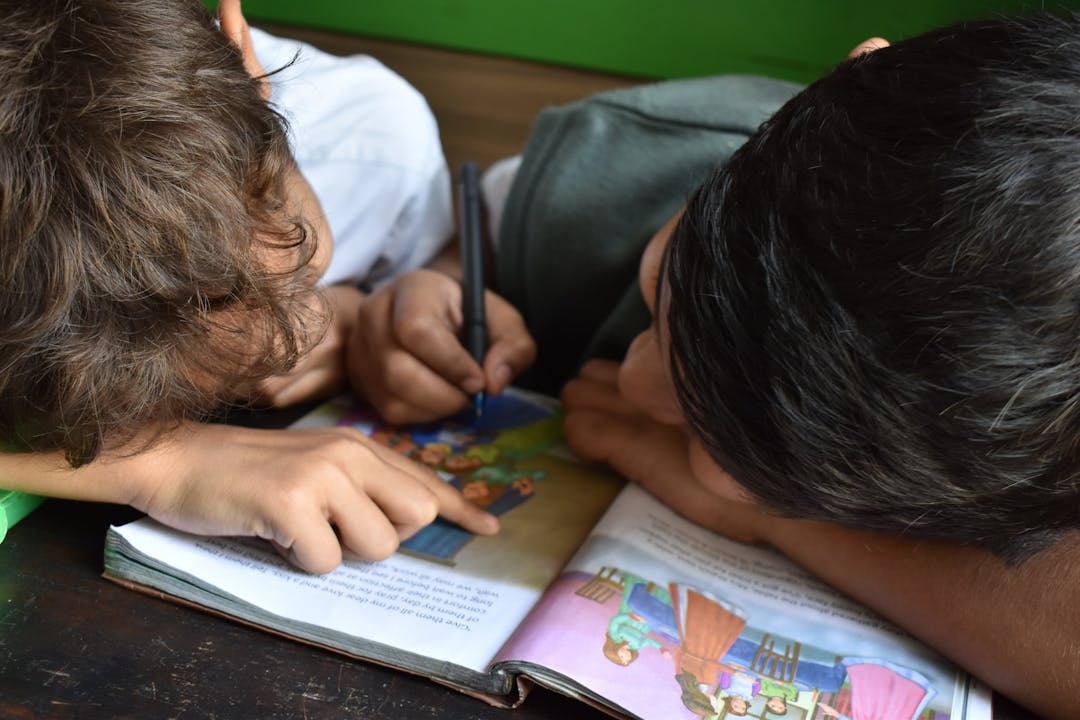 two children looking at a book