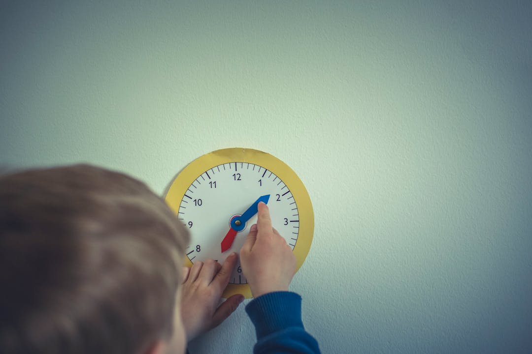 Young child playing with clock