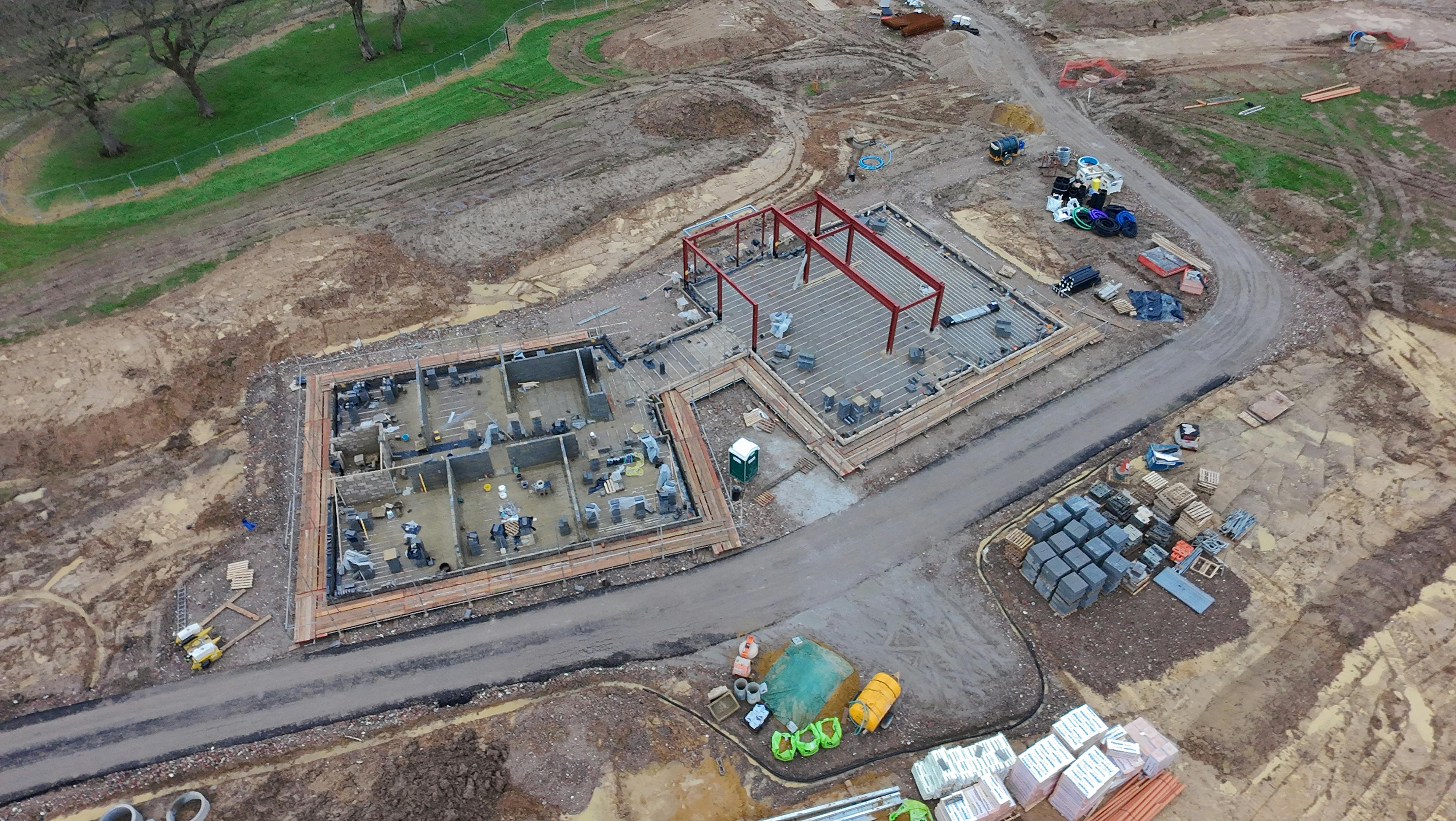 Close up on buildings, aerial view of site - March 2025