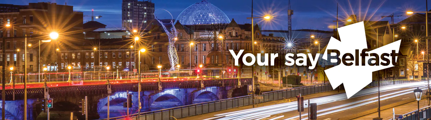 Photo of Belfast: The Beacon of Hope sculpture and Queen Elizabeth Bridge lit up at night - with Your say Belfast logo