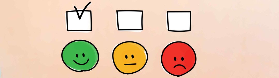An image of 3 boxes one with a tick inside and one green smiley face, one yellow straight face and one red sad face