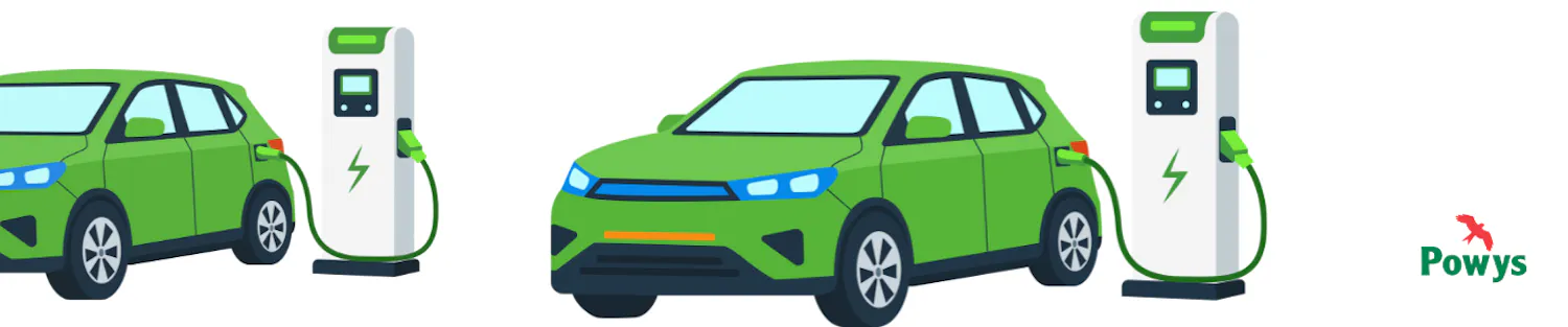Two green electric cars charging at a charging point