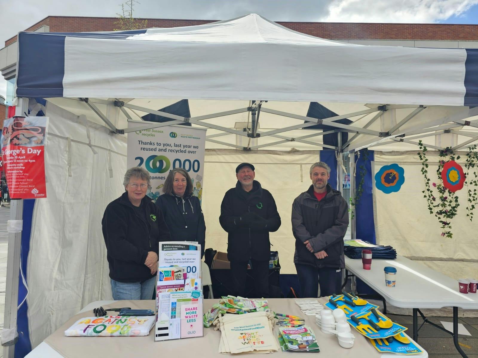 A group of people (male and female) at a waste prevention information stand