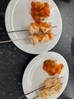 Chicken skewers cooking