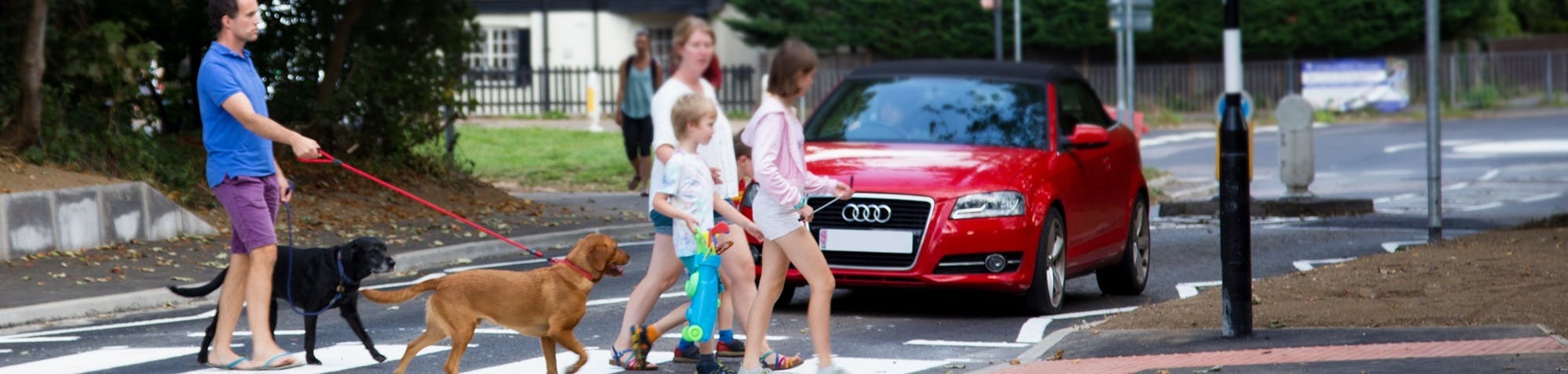 Family crossing a road