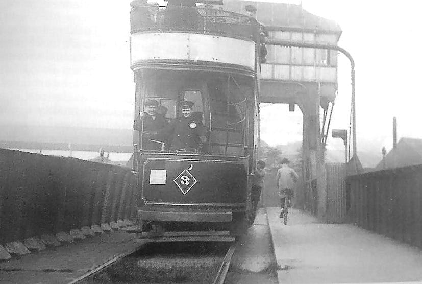 Bascule Bridge With Tram on it, spot the child clinging on and the man on a bicycle too. This single track often required the tram to be pushed over the unconnected part where the bridge lifted, other times the momemtum would carry it across...