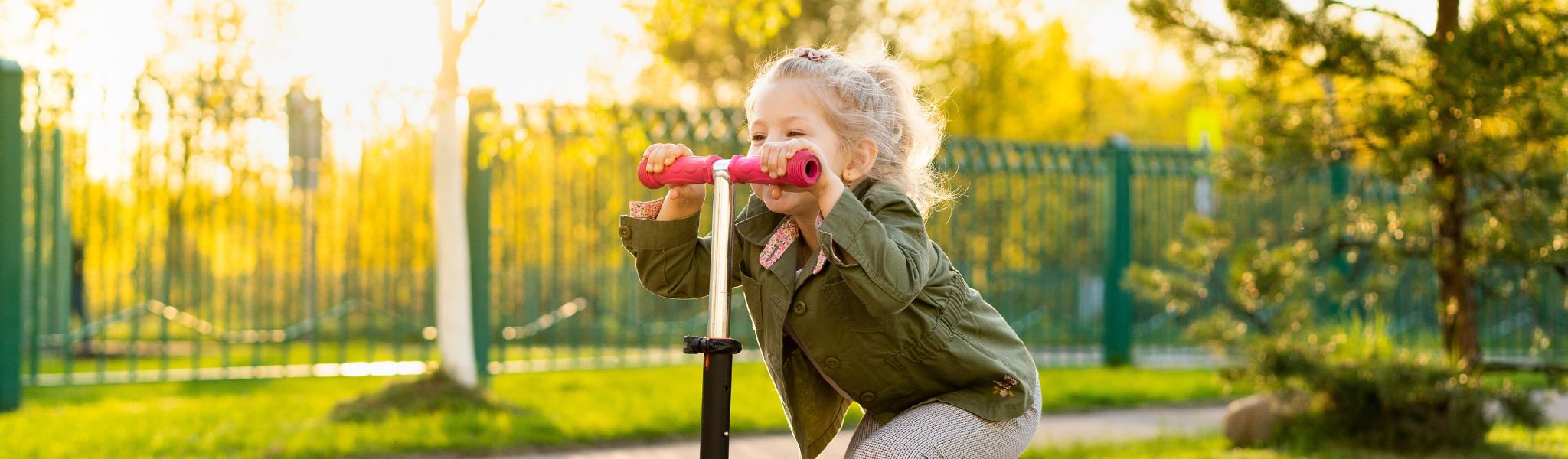 An image of a young girl on a scooter