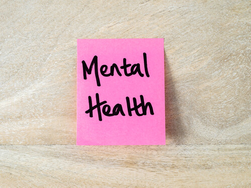 Pink post it that says mental health