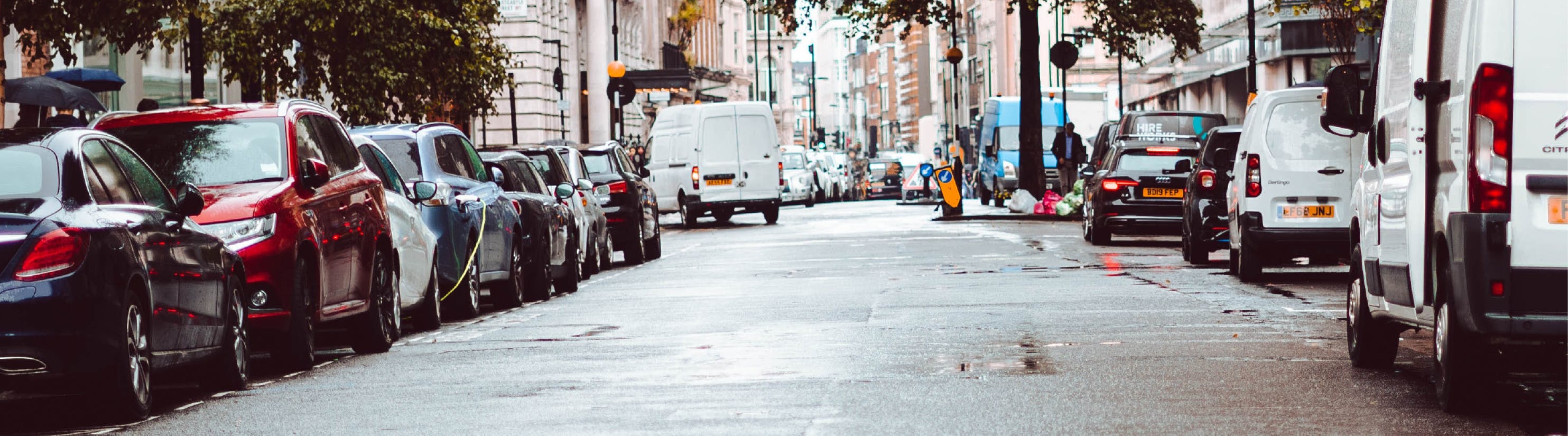 Photo of vehicles parked on either side of road.