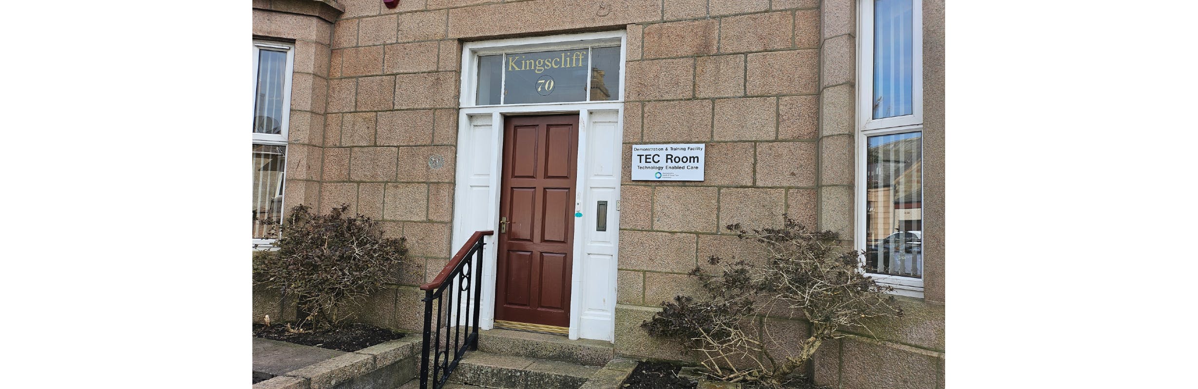 Exterior photo of building with TEC Room sign