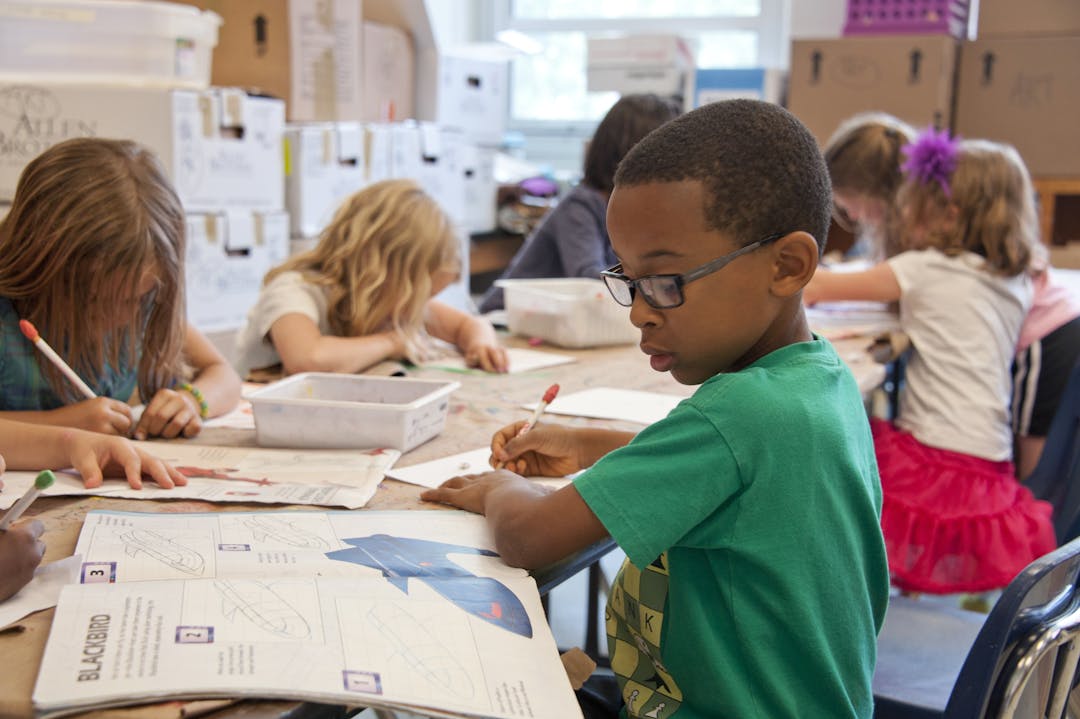 Image shows young people looking at books